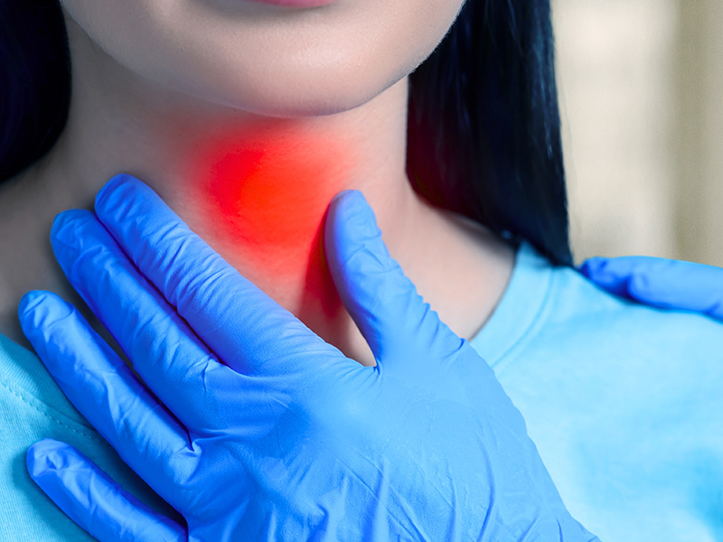 A woman experiencing thyroid pain